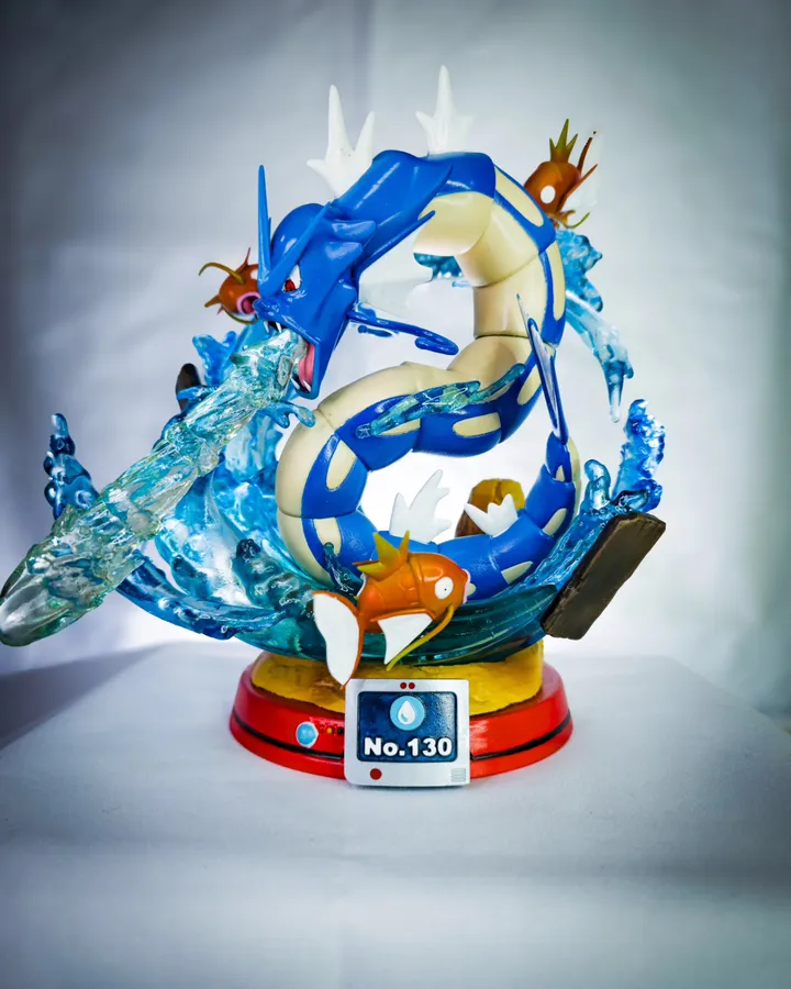 Diorama pintado de una serpiente marina azul rodeada de peces naranjas y olas translúcidas